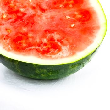 Half cut of organic watermelon isolated on white background. Summer refreshment fruit with clipping path and copy space.