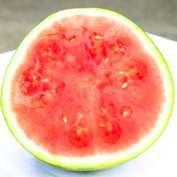 Half cut of organic watermelon isolated on white background. Summer refreshment fruit with clipping path and copy space.