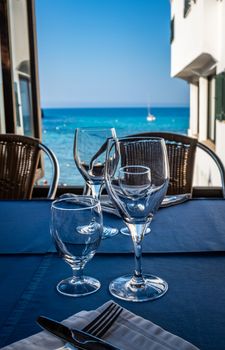 Glasses At A Luxurious Restaurant Overlooking The Ocean With Yachts