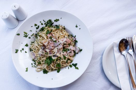 Carbonara pasta, spaghetti with pancetta, egg, hard parmesan cheese and cream sauce. Traditional italian cuisine. Pasta alla carbonara