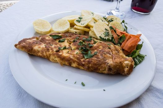 ham omelette with french fries and salad