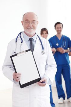 Smiling team of doctors and nurses on white background