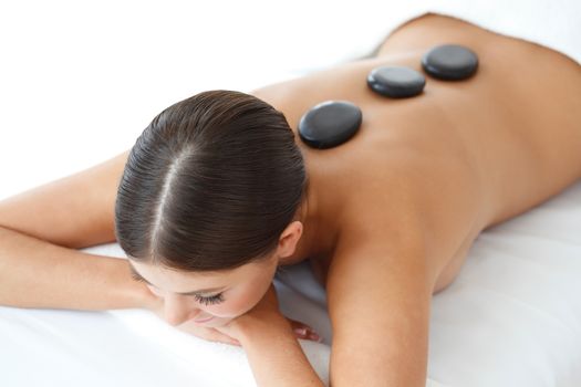 Girl on a stone therapy, hot stone massage