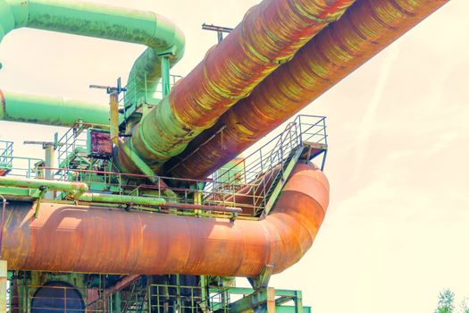 General view of an industrial plant refinery, consisting of pipes and towers of heavy industry.