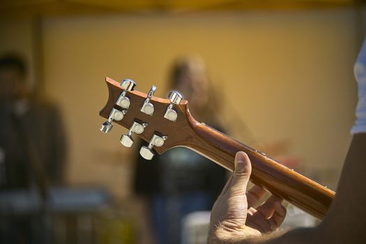 Detail of the blade and mechanics of an electric guitar while playing live at a concert