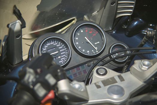 speedometer of a modern enduro bike, detail of the instrument cluster with a handlebars.