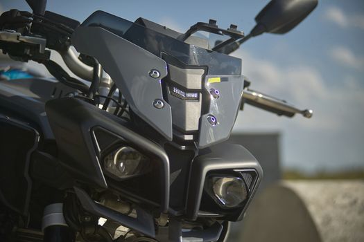 snout and fairing of a modern bike with eye-catching and sporty design, detail of the lenticular light.