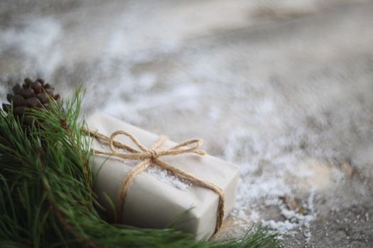 Simple Christmas gift on wooden background with snow