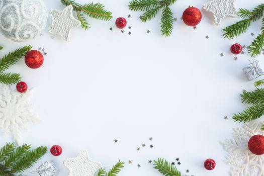 Christmas card white background with stars baubles fir tree branches and red berries border frame with copy space