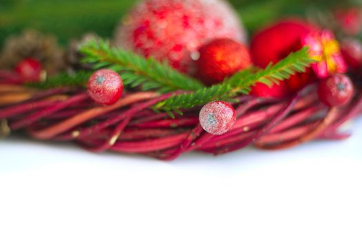 Christmas wreath of fir tree branches decorative beaubles and red berries isolated on white background copy space for text