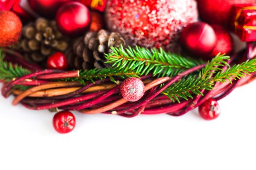 Christmas wreath of fir tree branches decorative beaubles and red berries isolated on white background copy space for text