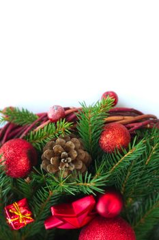 Christmas wreath of fir tree branches decorative beaubles and red berries isolated on white background copy space for text