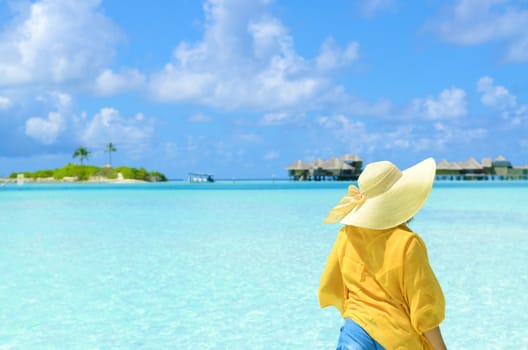 Portrait of happy young woman at  Maldives island. Travel and Vacation. 