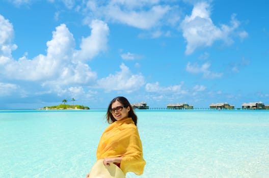 Portrait of happy young woman at  Maldives island. Travel and Vacation. 