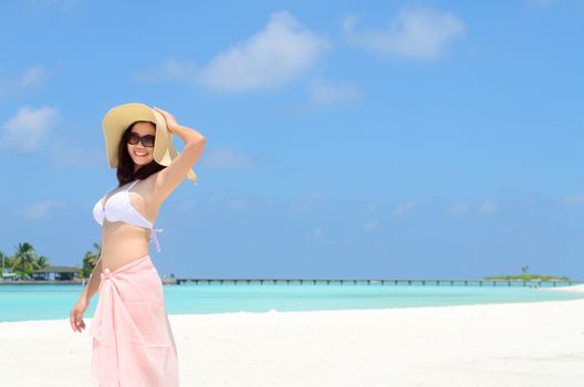 Portrait of happy young woman in sunhat at  Maldives island. Travel and Vacation. 