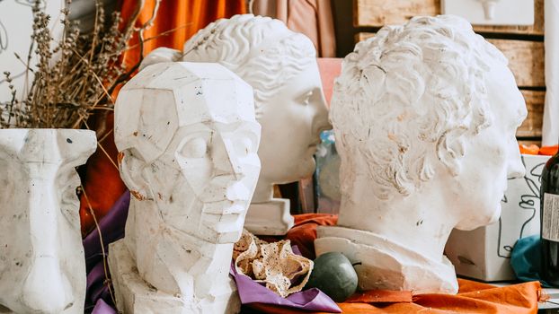 Sculpture bust and tools in an art workshop background