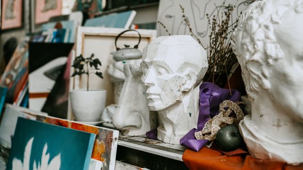 Sculpture bust and tools in an art workshop background