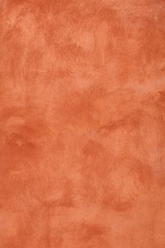 Grunge orange brown faded uneven old aged daub plaster wall texture background with stains and paint strokes, close up