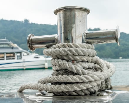 Mooring post on small boat on beautiful green water