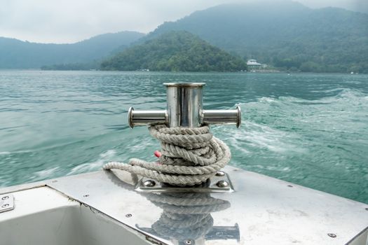 Mooring post on small boat on beautiful green water