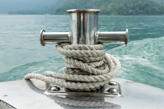 Mooring post on small boat on beautiful green water