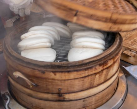 Steamed Taiwanese Guo Bao Buns in a Bamboo Steamer