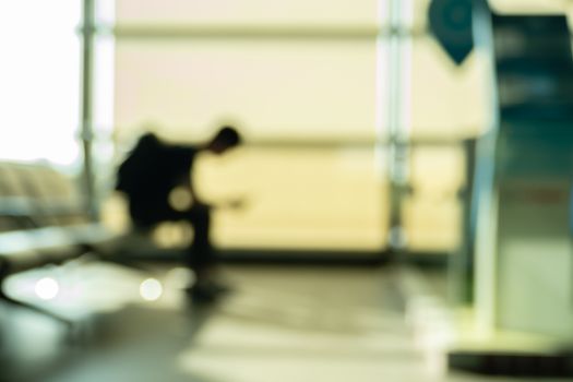 Defocused solitary passenger in waiting area seats