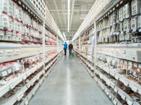 Abstract blurred store for home improvement and DIY. Warehouse aisle of building materials in industiral store. Blur