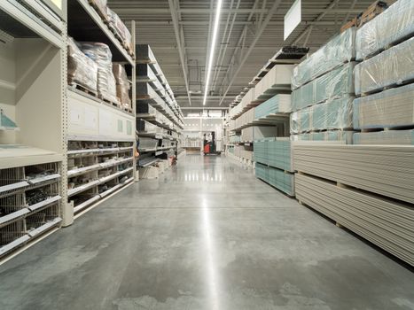 Store for home improvement and DIY. Warehouse aisle of building materials in industiral store. Shallow DOF