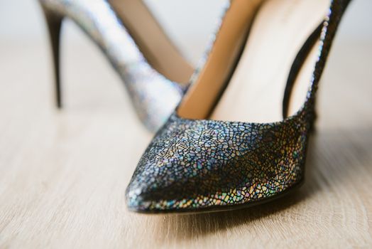 Black high heel women shoes isolated on wooden table