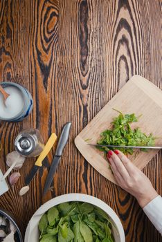 composition poured olive oil, mushrooms, garlic on wooden background. healthy food