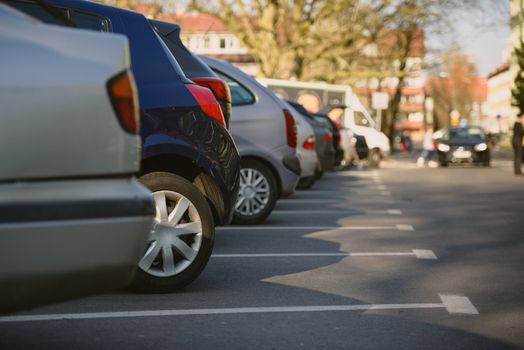 View of tightly packed cars in parking lot.