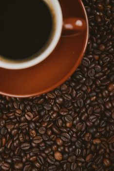 Coffee cup and beans on a background