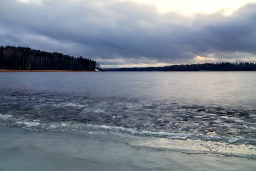 first ice on the lake in late autumn. Winter Coming Landscape.