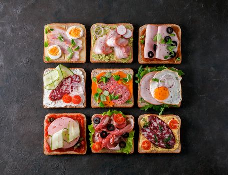 Set of eight different sandwiches with meat in square shape. Top view or flat lay. Assortment meat toasts on black background. Idea, creative concept for sausage maker