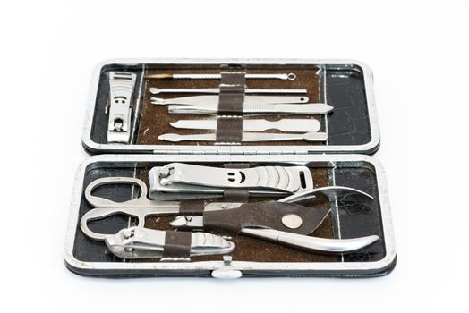 Close-up pedicure kit, nail clippers, professional grooming kit, nail tools with travel case isolated on white background.