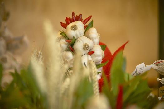 Garlic head with chili pepper in a market stand.