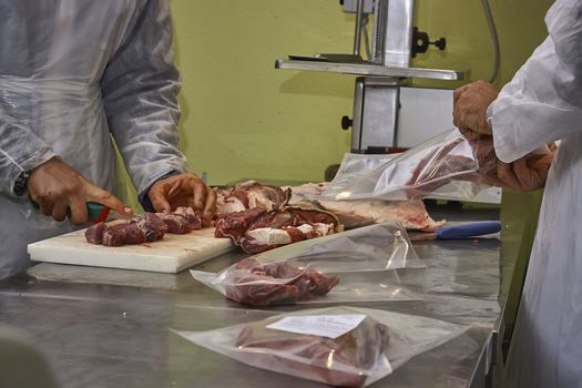 a department of a butcher shop where the pieces of meat are cut and then placed in a plastic buster to be stored under vacuum.