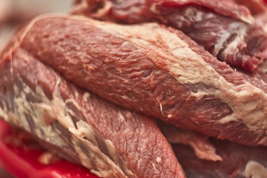 Detail of the fibers of a cut of veal with macro shot made in a butcher shop. Red meat from organic farming.