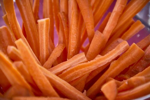 Carrots sliced in julienne and arranged in an artistic composition to embellish the table for a lunch or aperitif.