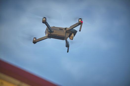 Drone while flying from below, as it is moving towards the predetermined direction. Drone flying while resuming from above.