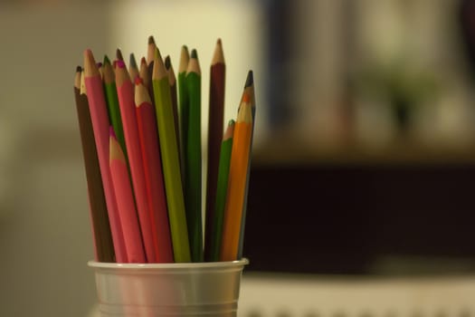 container full of colored pencils ready to draw