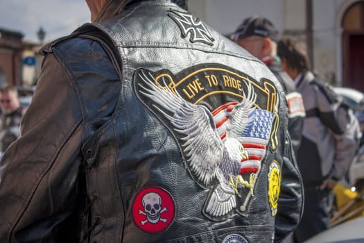 Detail of the leather handkerchief of an Italian biker. Coat of arms and colorful colors of this lifestyle.