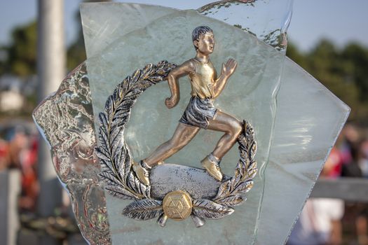 Glass and metal trophy for the first place for a sporting event of walking, marathon, racing.