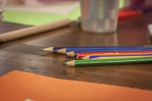Colorful wooden pencils leaning over a drawing board in a classroom of a design school.