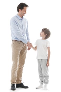 Cheerful father and son shaking hands isolated on white background