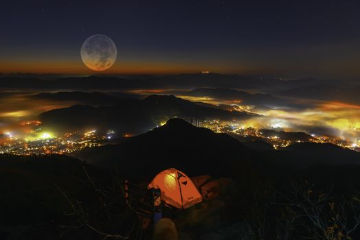 Moon rise In the autumn on the top of Cheonmasan Mountain at night in Seoul, South Korea.