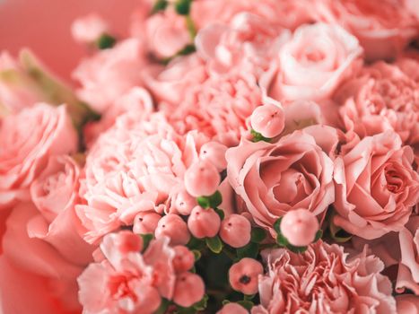 Beautiful bouquet with roses, dianthus, hypericum, clove in color of year 2019 Living Coral concept. Trendy color Living Coral in flowers, wedding bouquet. Shallow DOF.