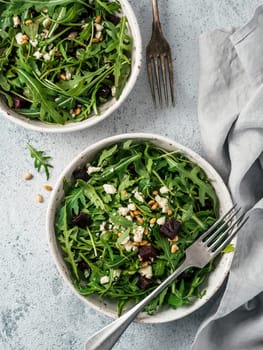 Beetroot, aragula and soft cheese salad over gray background. Top view or flat lay. Copy space for text. Idea and recipe for healthy vegetarian summer salad. Clean eating diet concept