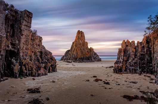 Pyramid rock sea stack long exposure movement of clouds across the sky during the dawn sunrise. South Coast Australia